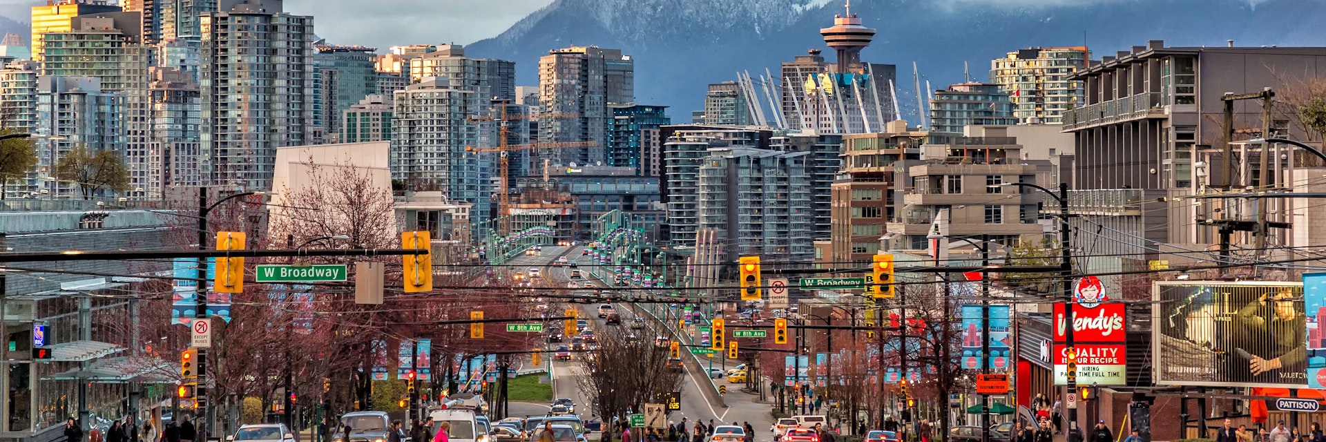 Downtown Vancouver during the day with snow-capped mountains across the strait.