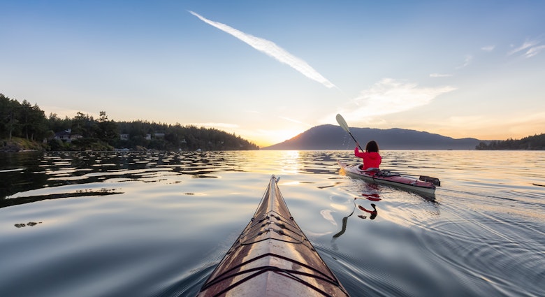 Adventurous Woman on Sea Kayak paddling in the Pacific Ocean. Sunny Summer Sunset. Taken near Victoria, Vancouver Islands, British Columbia, Canada. Concept: Sport, Adventure, License Type: media, Download Time: 2025-02-25T22:04:58.000Z, User: rhylton_redventures, Editorial: false, purchase_order: 56530 - Guidebooks, job: Lonely Planet WIP, client: Lonely Planet WIP, other: Rhianydd Hylton