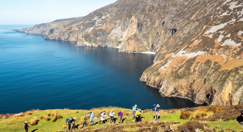 Sliabh Liag, Ireland - 04.21.2024: Group of hikers on footpath into mountains, beautiful cliff and ocean nature background. Travel and tourism industry. Warm sunny day., License Type: media, Download Time: 2024-11-26T12:04:08.000Z, User: clairenaylor, Editorial: true, purchase_order: 65050 - Digital Destinations and Articles, job: Online editorial, client: Ireland best things to do, other: Claire Naylor